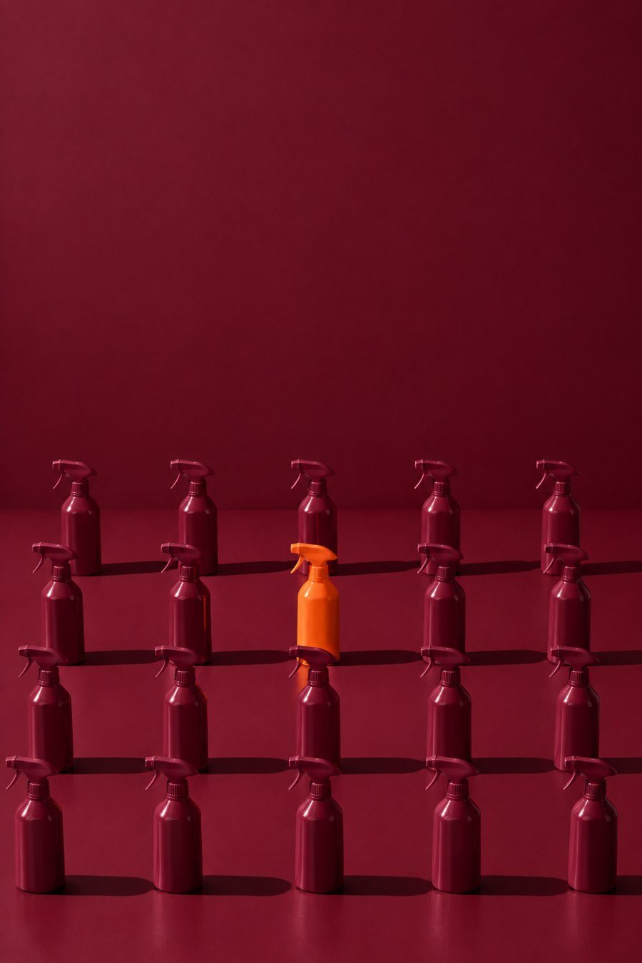 Keystone studio set: rows of oxblood spray bottles with one orange bottle