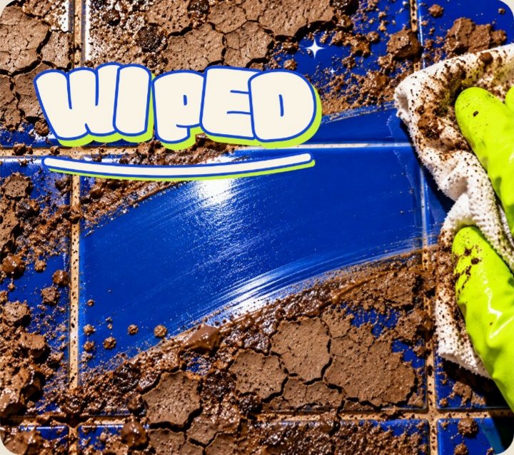 The Wiped logo revealed on a cobalt tile wiped clean through cracked mud